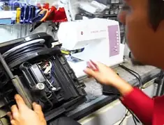 Vacuum repair technician servicing internal components on a workbench in Fort Collins, CO