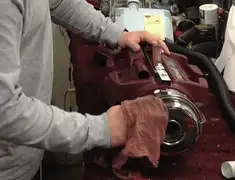 Vacuum repair technician cleaning and servicing a vacuum motor in Fort Collins, CO